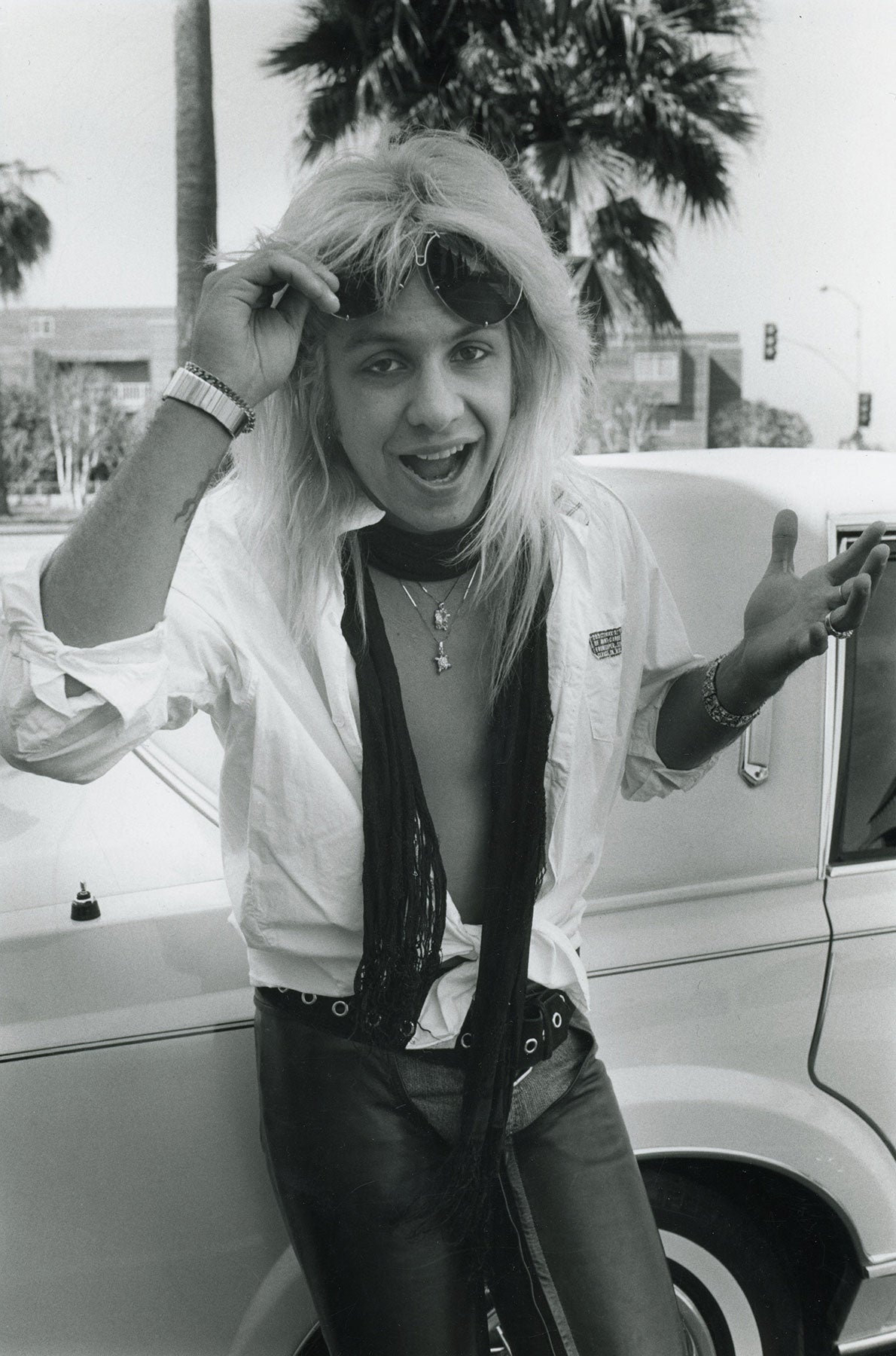Vince Neil lying on a Cadillac in Los Angeles circa 1983