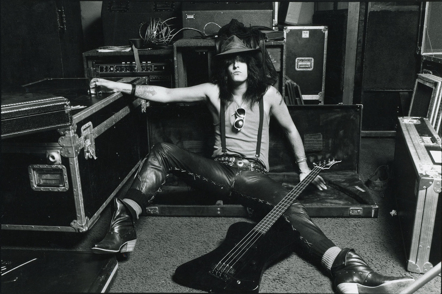 Nikki Sixx poses with his bass guitar and other instruments
